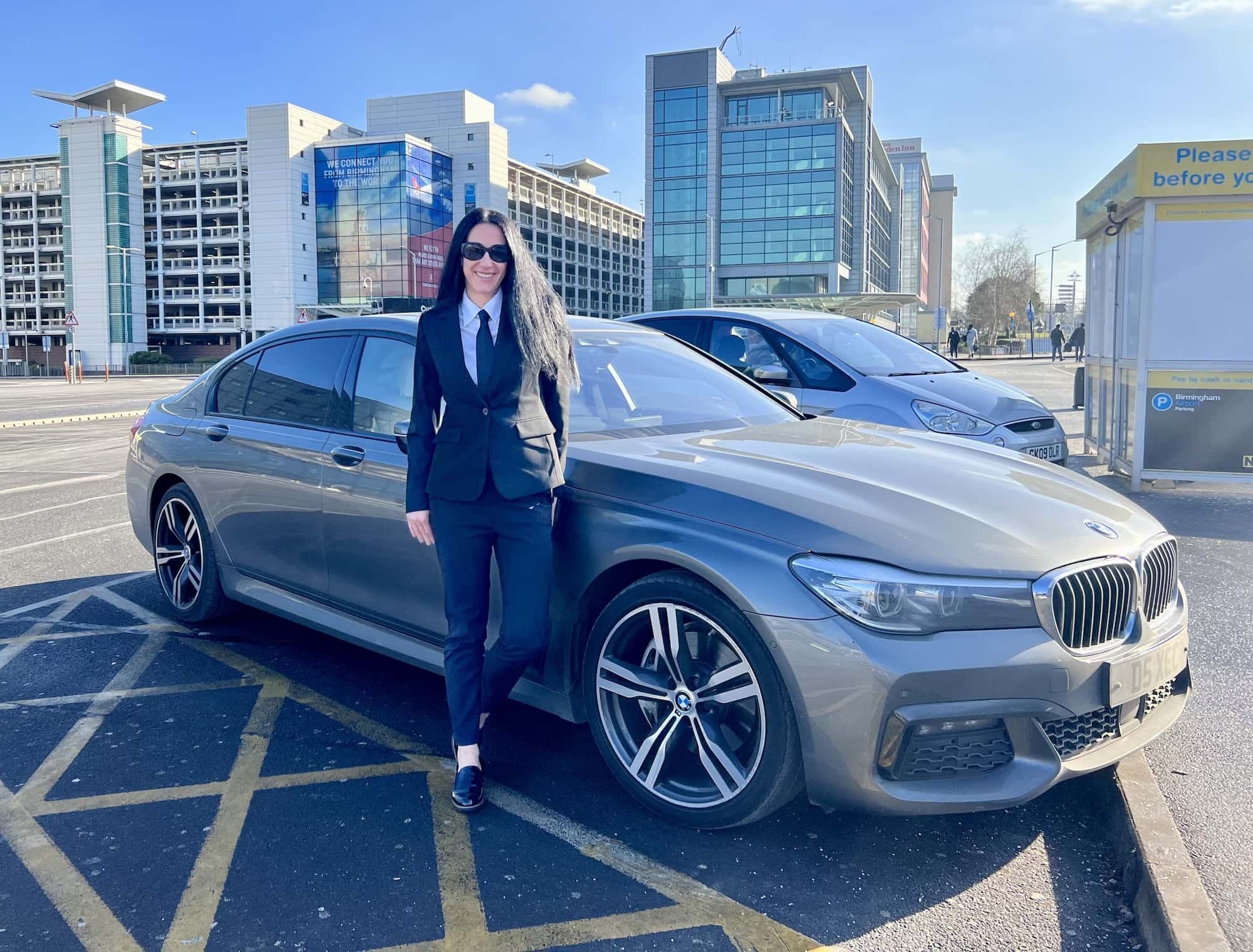 Our Female Chauffeur with the BMW 7 Series at Birmingham Airport