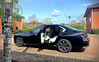 BMW i7 luxury chauffeur car with passenger door open ready for executive travel in Derby