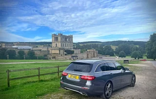 Mercedes chauffeur car overlooking Chatsworth House during a private Derbyshire tour