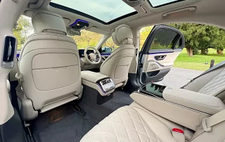 Luxury Mercedes S Class rear passenger interior with cream leather seats